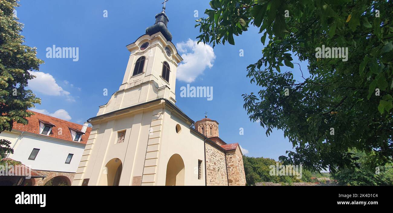 A panoramic low-angle shot of the Mesic Monastery in Serbia against a blue cloudy sky Stock Photo