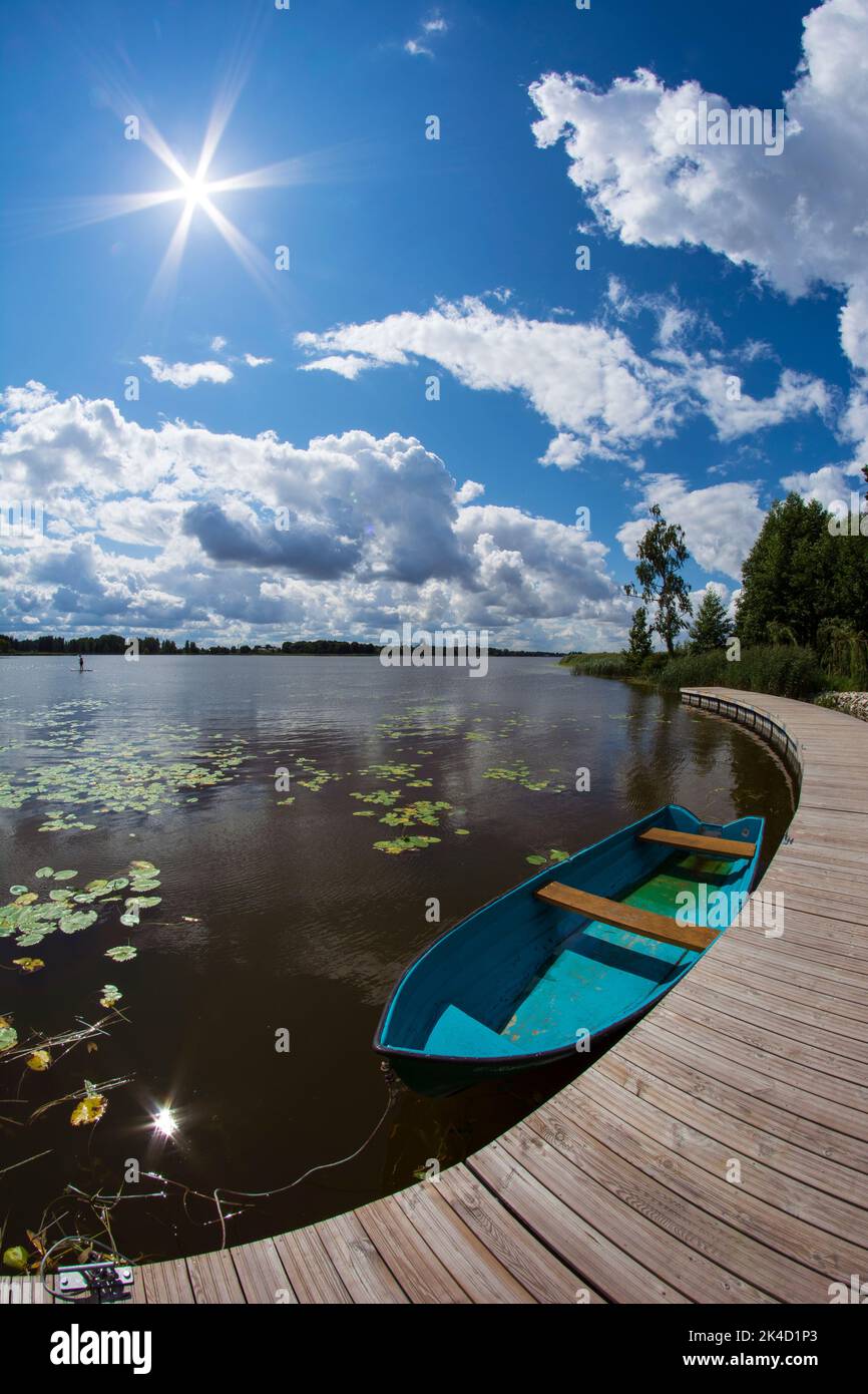 Summer lake with wooden pier and boat, fisheye view Stock Photo