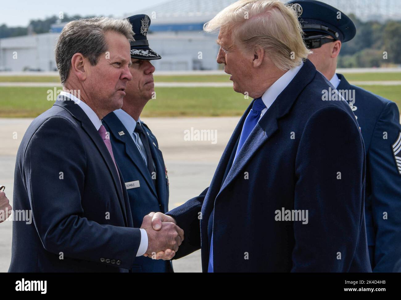 President Donald Trump shakes hands with Georgia Governor Brian Kemp at Dobbins Air Reserve Base in Marietta, Georgia, on November 8, 2019. The President greeted military and community members briefly before heading into Atlanta to attend an event. (USA) Stock Photo