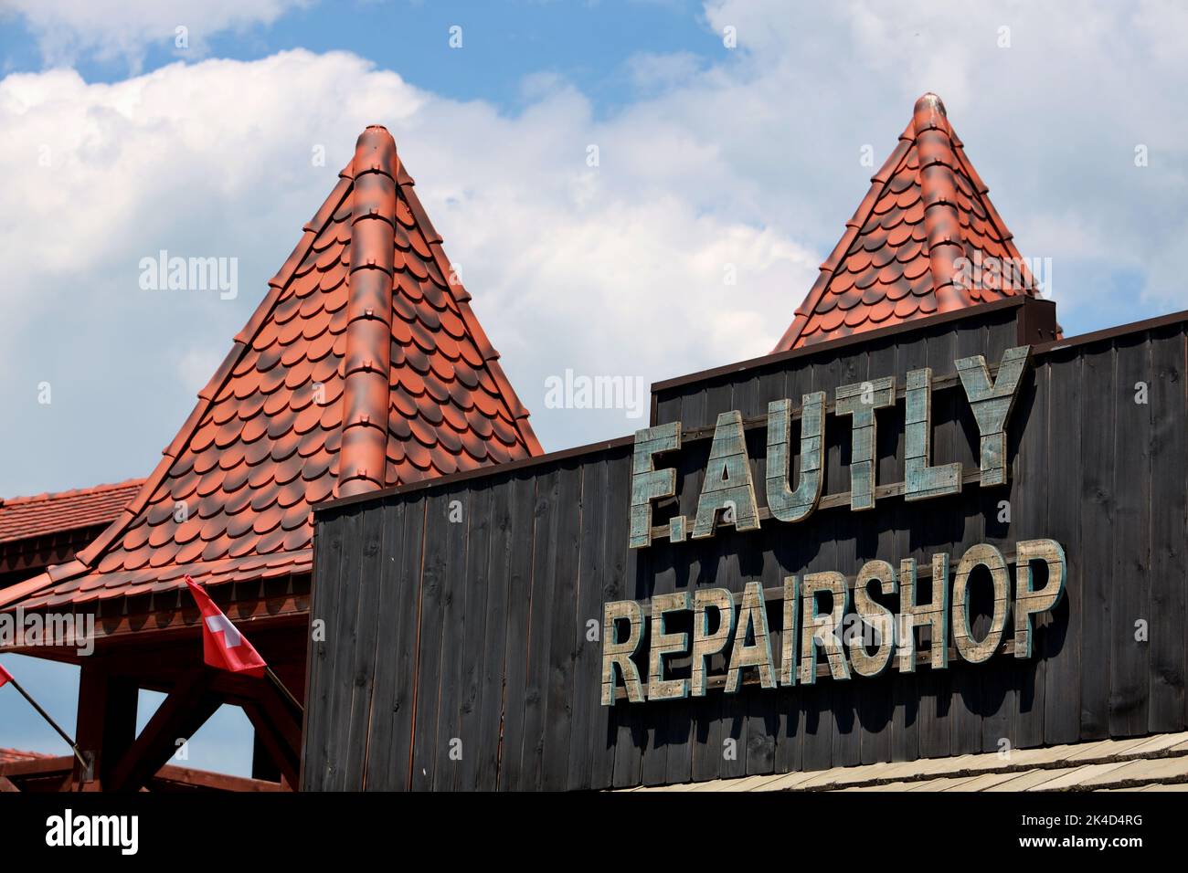 A low angle of 'Faulty repairshop' lunapark attraction during the summertime Stock Photo