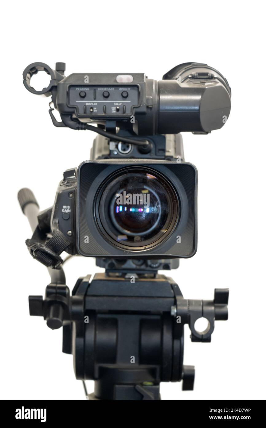 Old studio video camera on tripod, a front view, isolated on white background Stock Photo