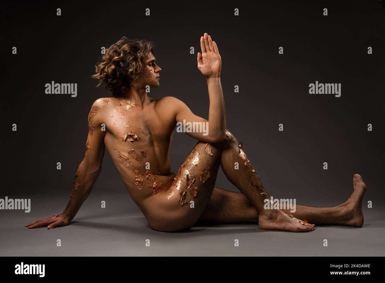 Naked young man doing Seated Spinal Twist pose Stock Photo