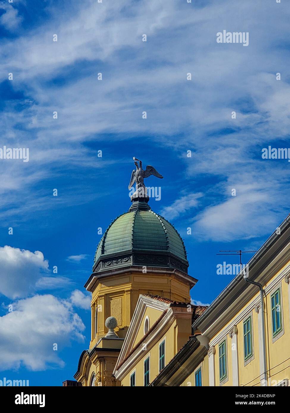 The baroque clock tower with domed roof and sculpture of the two-headed eagle in Rijeka, Croatia Stock Photo