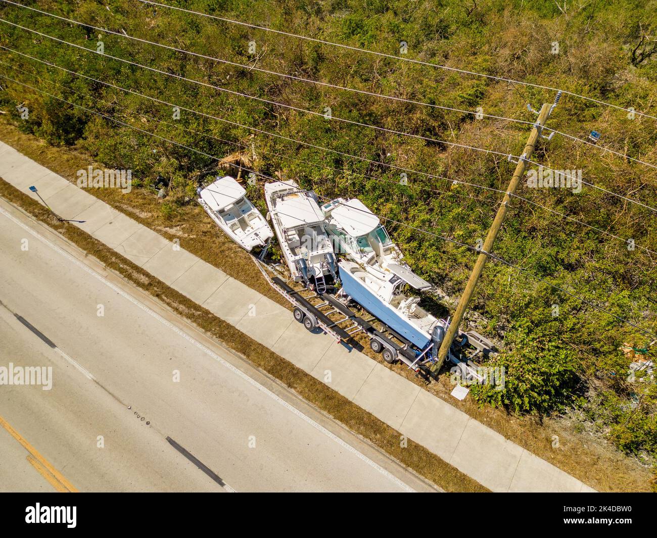 Fort Myers, FL, USA - October 1, 2022: Aerial photo of boats tossed on the side of the road by heavy winds from Hurricane Ian Fort Myers FL Stock Photo