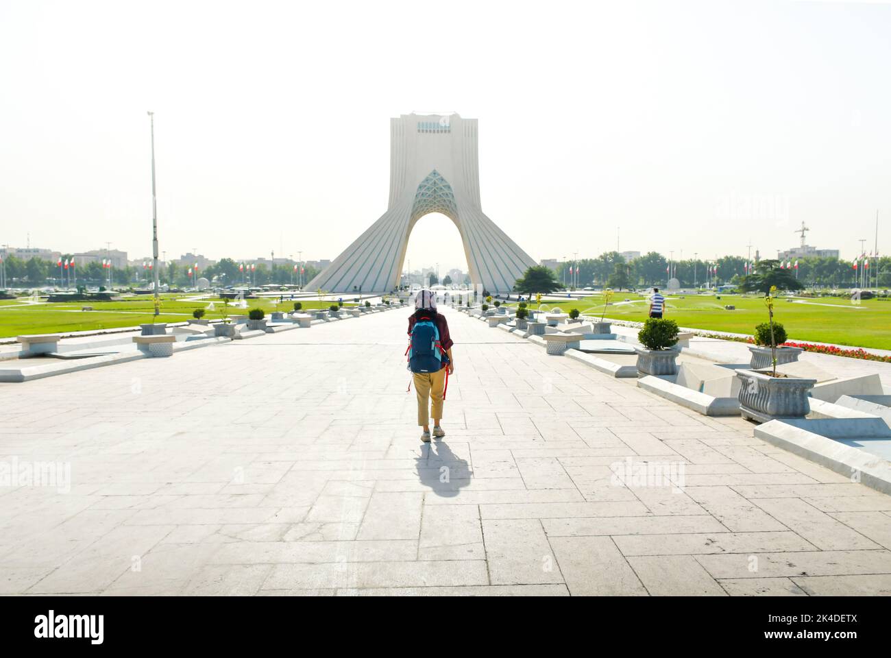 13th june, 2022: backpacker woman walk by Azadi tower - famous landmark in Tehran in capital of Iran. Woman rights and and tourism in middle east Stock Photo