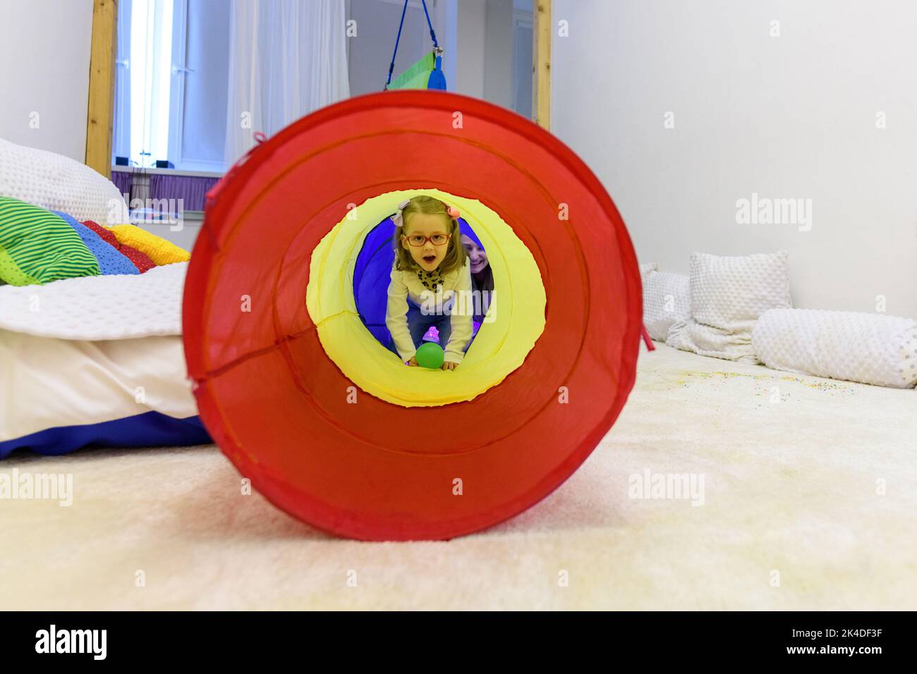 Child with physical disability in sensory stimulating room, snoezelen