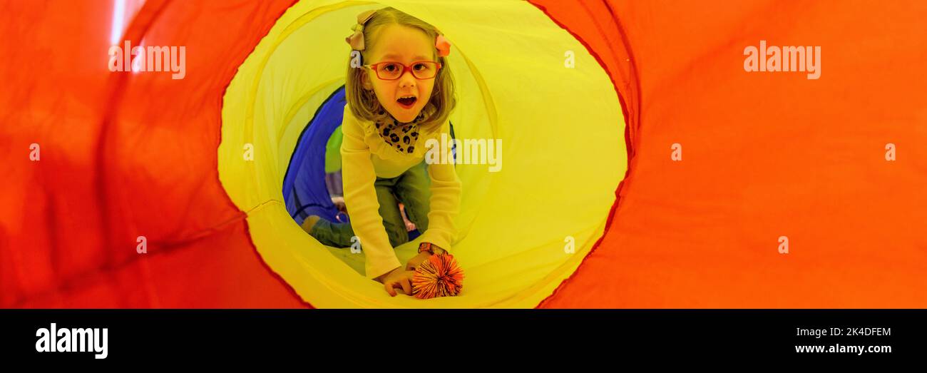 Girl living with cerebral palsy playing in sensory room, snoezelen