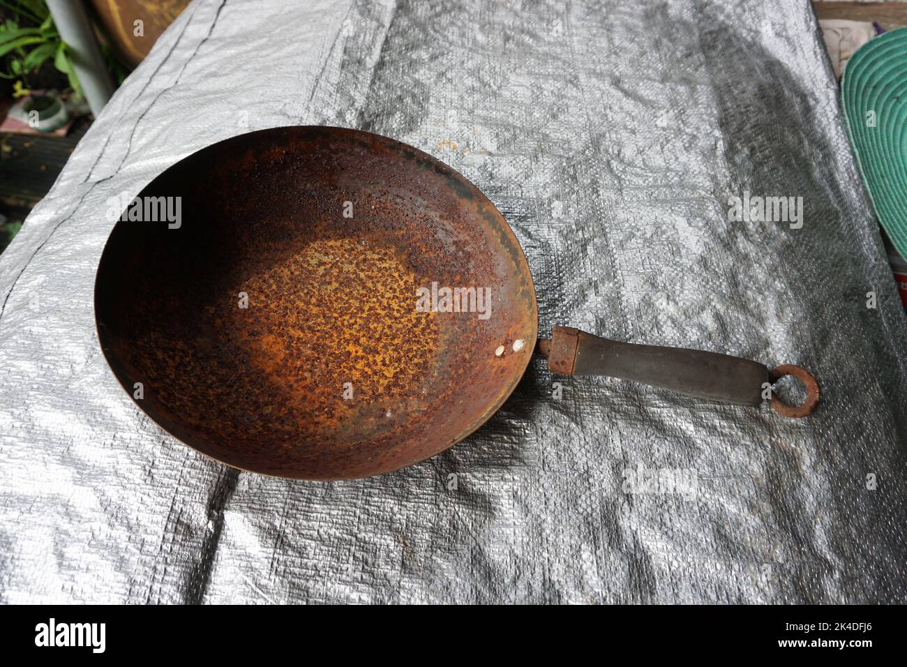 The texture of an old and rusted steel plate is used as a design , old  pan Stock Photo