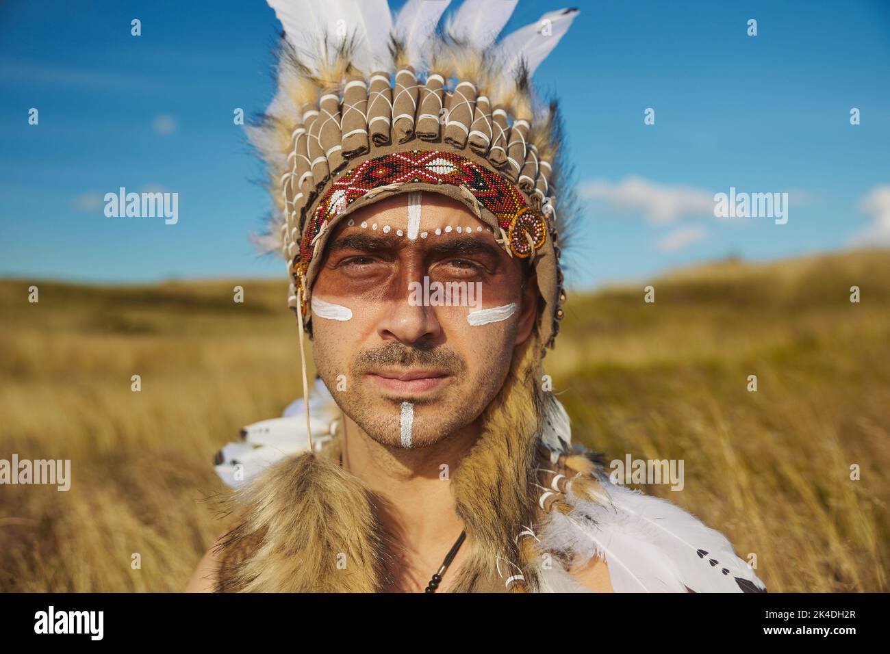 A man in traditional Native American clothing in the steppe Stock Photo