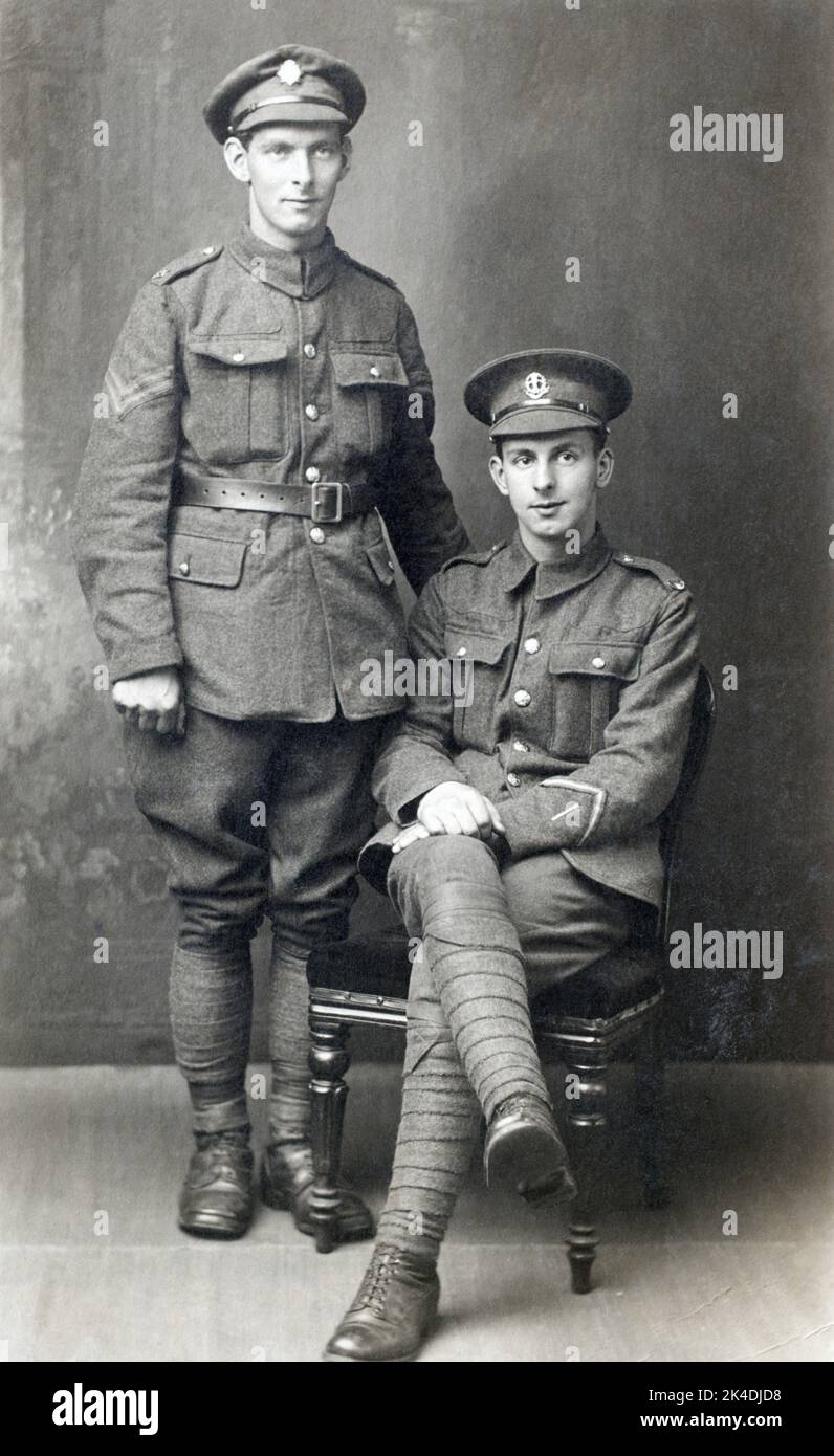 A First World War era picture of two British soldiers, a Corporal in the Army Service Corps (left) and a Lance Corporal in the Middlesex Regiment (right) Who has a long service & good conduct stripe and a wounded strip. Stock Photo