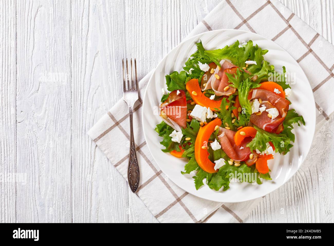 pumpkin salad with lettuce, crumbled feta cheese, thinly slices of cold