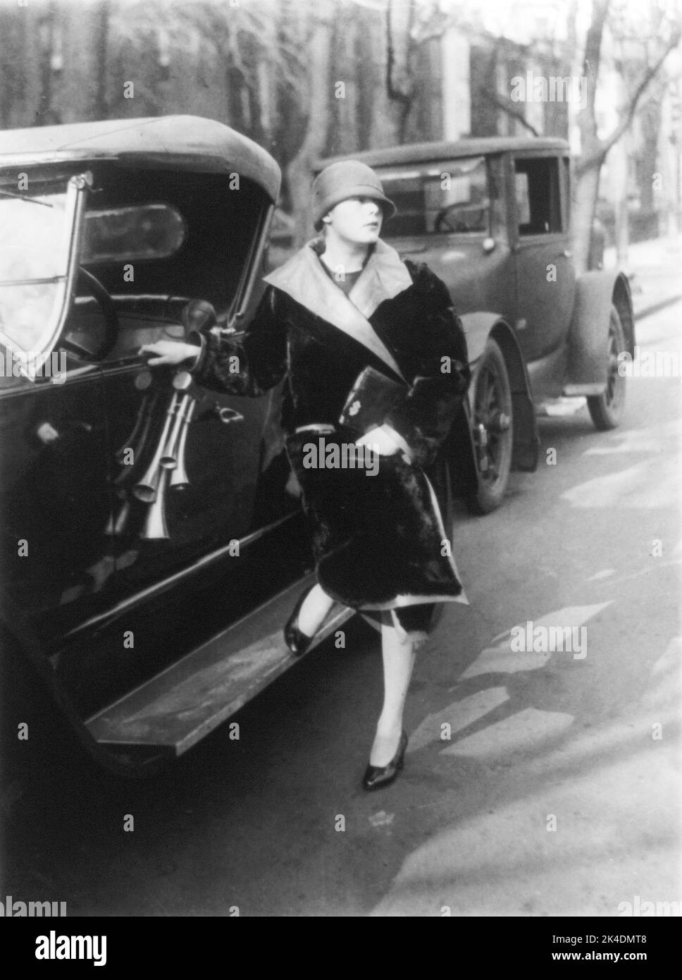Suzette Dewey, daughter of Charles Dewey, posed beside roadster, December 29, 1926 Stock Photo