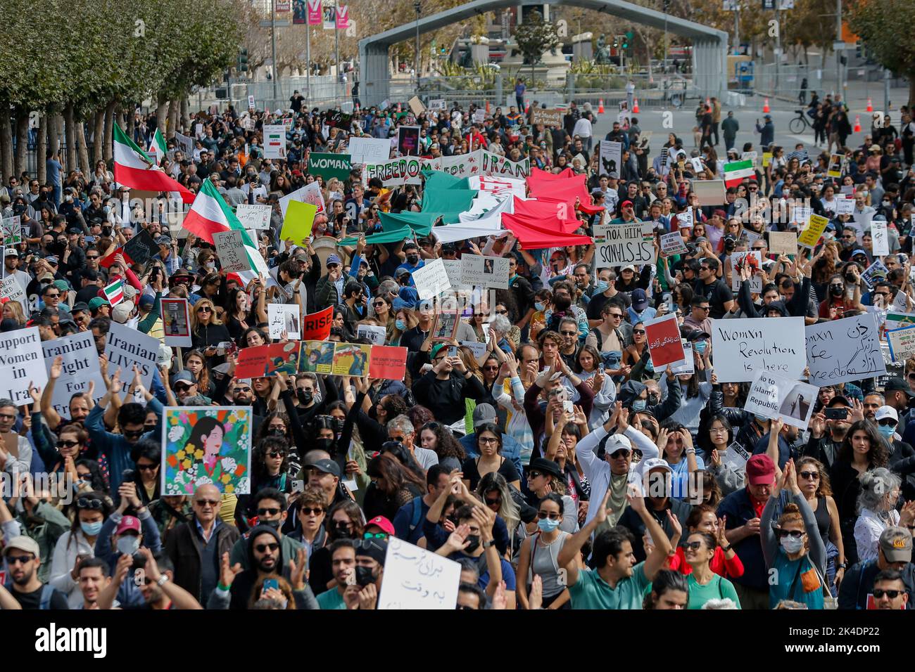 People rally outside the city hall of San Francisco with placards and ...