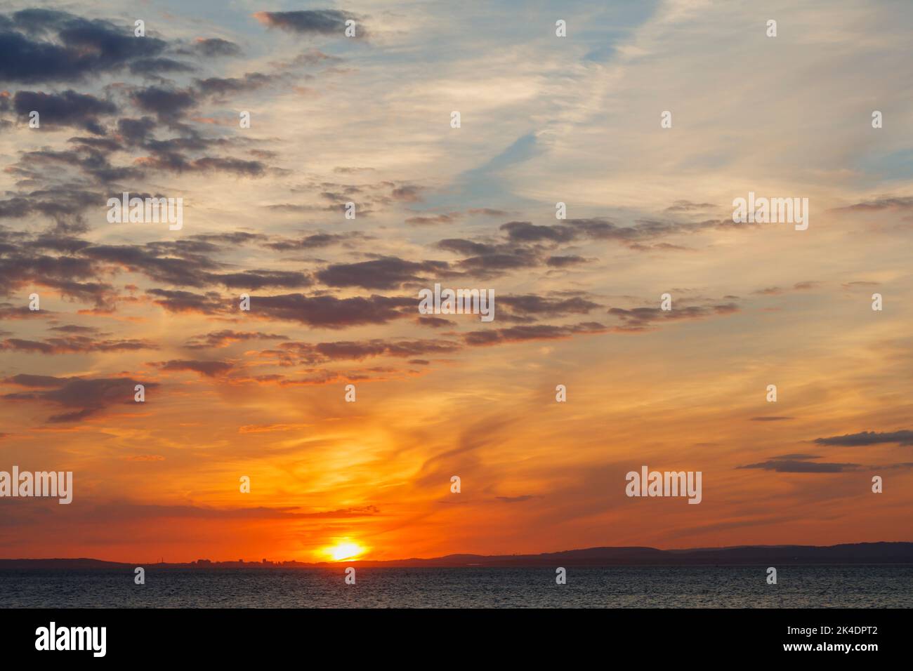 The sun about to set over the horizon with a golden glow on the horizon ...