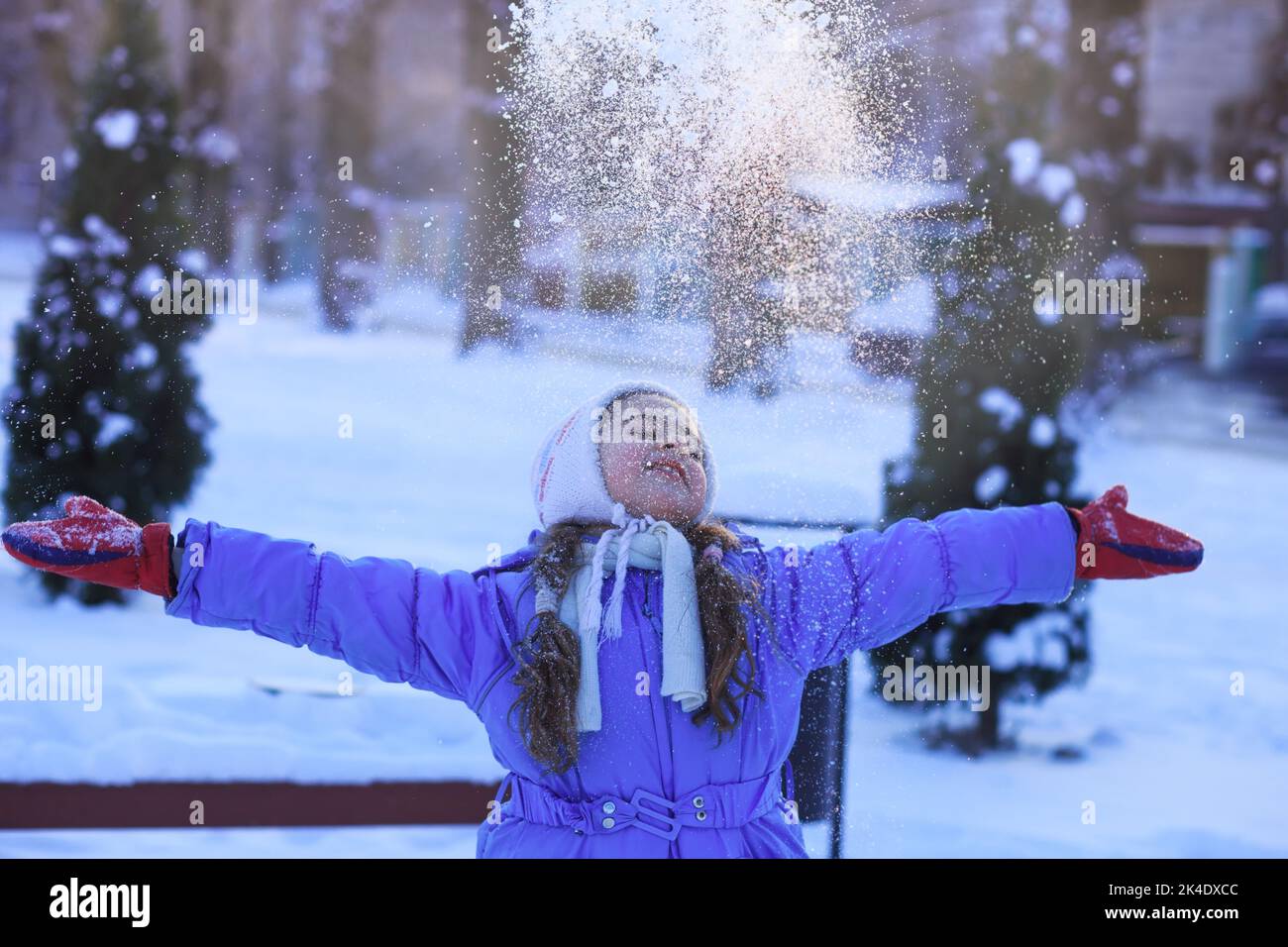 Winter little girl portrait. Beauty Joyful  Girl having fun in winter park. Enjoying nature, wintertime. Stock Photo