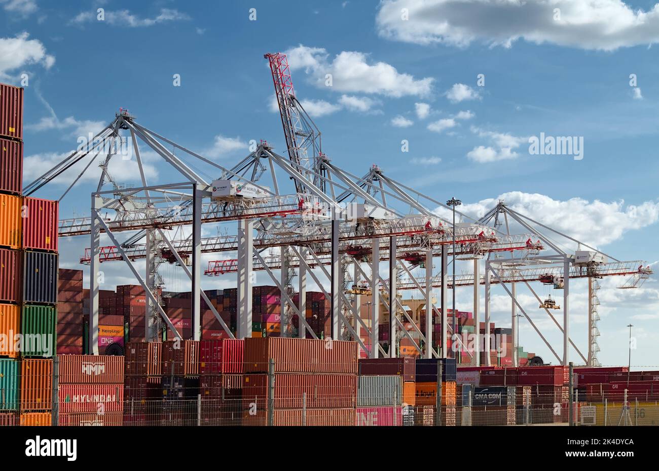 Tall Cranes And Stacked Shipping Containers On The Port Side At Southampton Docks, UK Stock Photo