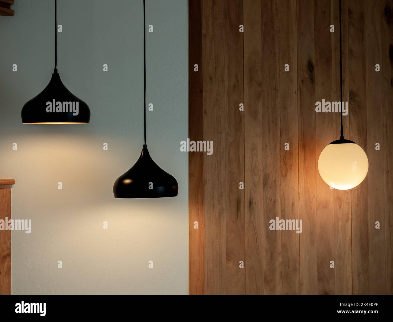 Twin ceiling lighting in the dark room. Two hanging lamp or round ceiling lamp decorated as a steps and round light full moon shape on white and wood Stock Photo