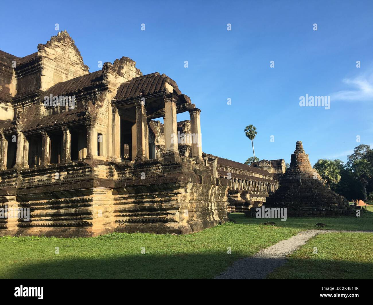 A low-angle closeup of an Angkor Wat temple ruins, precinct, and sky background Stock Photo