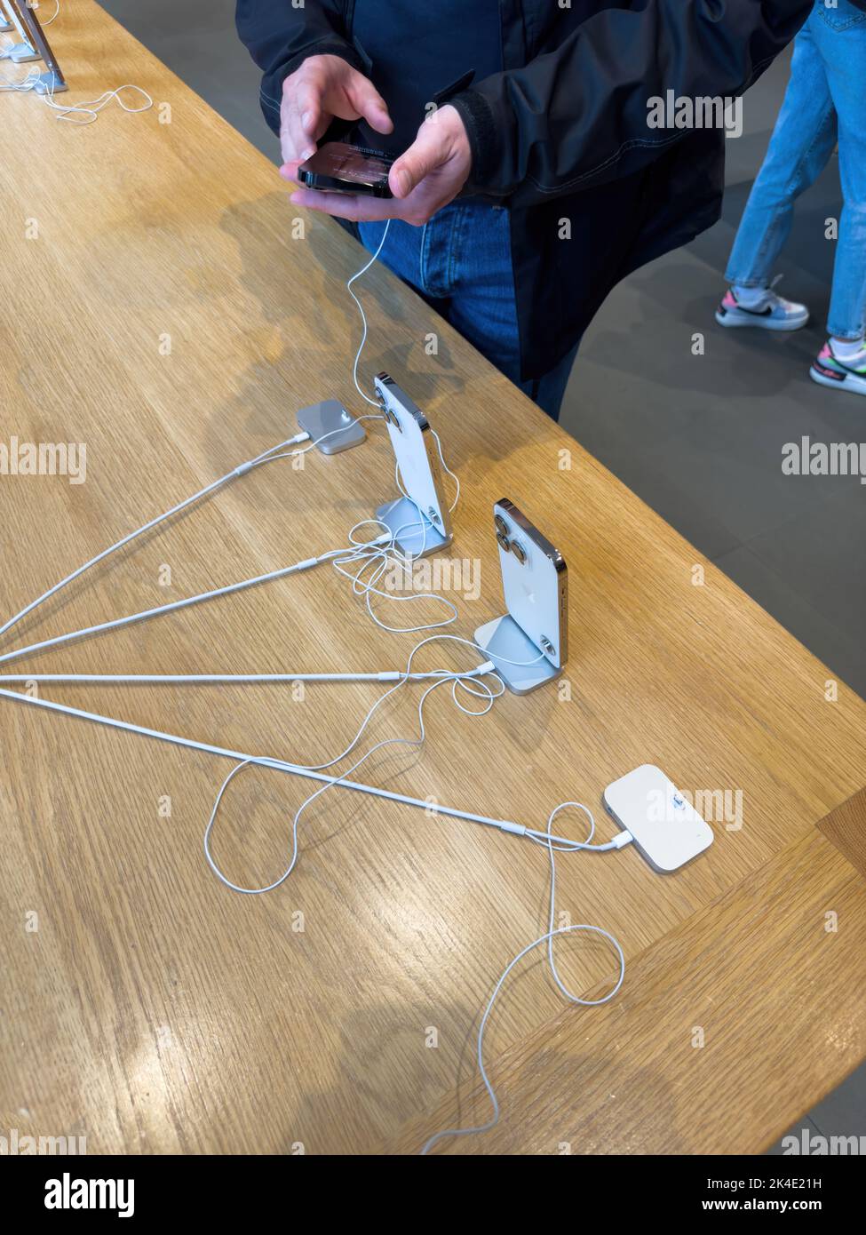 Paris, France - Sep 16, 2022: Man inspecting new phone: The Apple Computers iPhone 14, 14 Pro, Pro Max on sale during the launch day featuring Always-on display, 48-megapixel Main camera and Dynamic Island Stock Photo