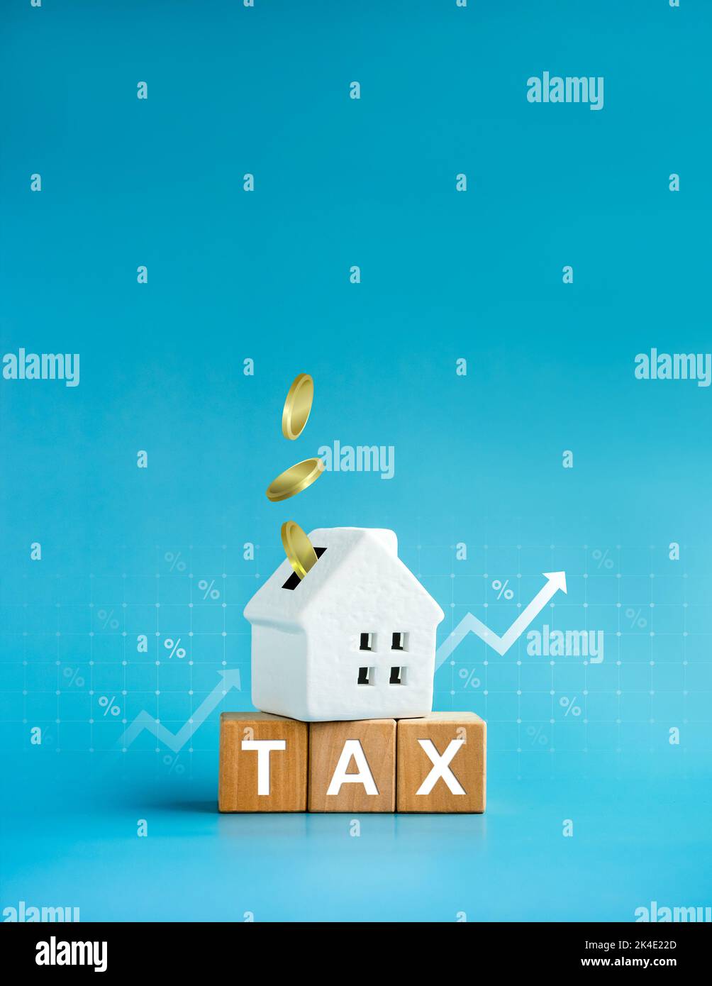 Home tax concept, residential, real estate property, land, building annual taxation. Word, Tax on wood blocks and coins fall in white small house, per Stock Photo
