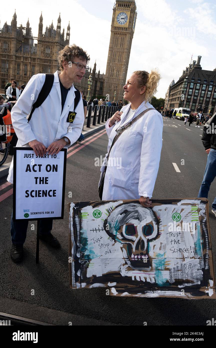 London. People protest against the oil industry and the cost of living crisis.Scientists in white coats. Stock Photo