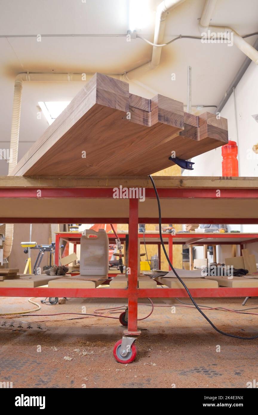 A man cuts wood on a circular saw in a joinery, band saw, holding a