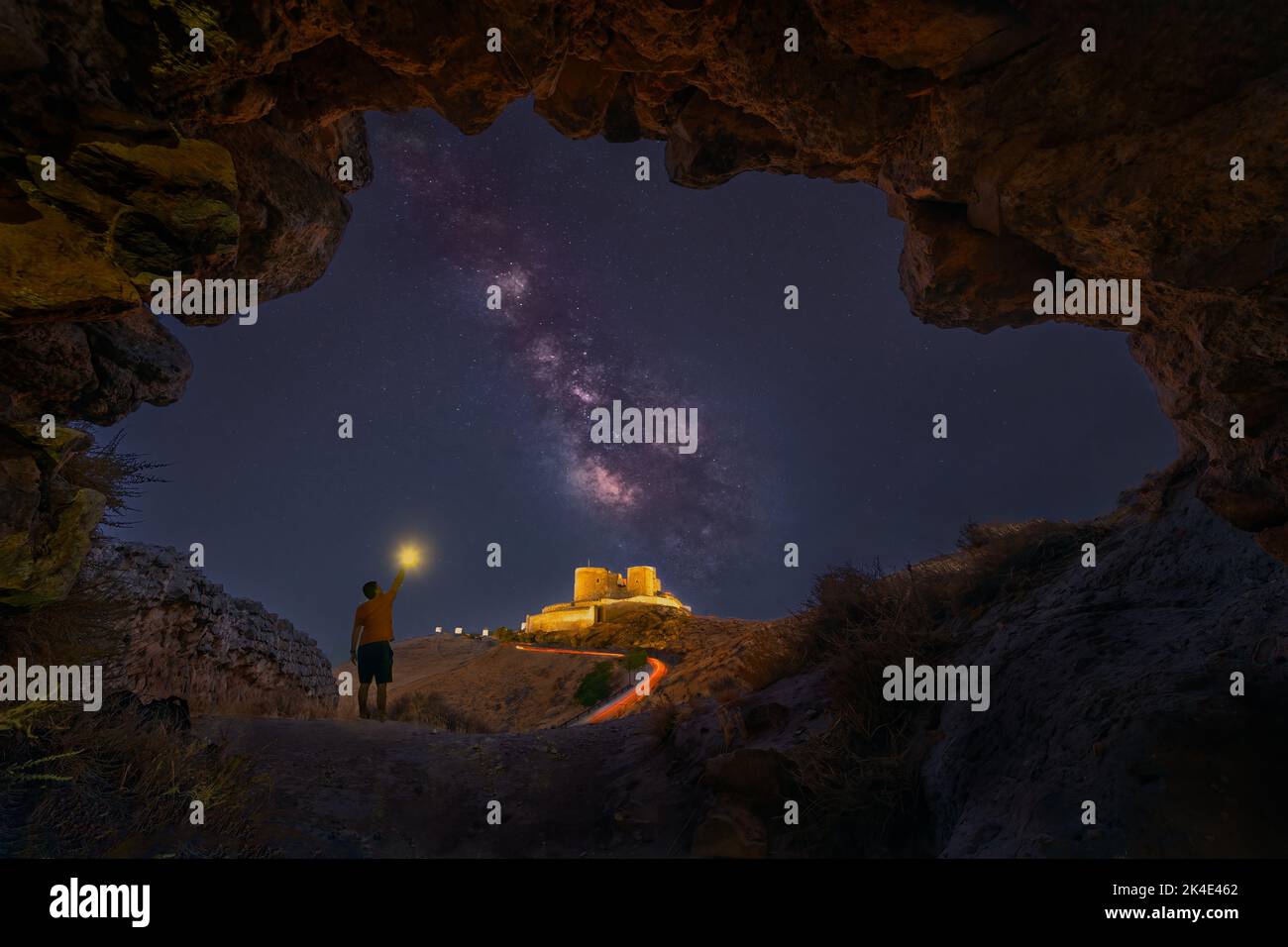 Man in consuegra castle illuminating the Milky Way Stock Photo