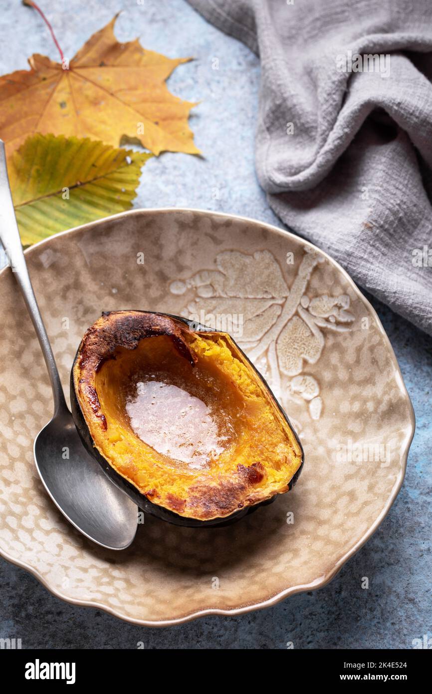 Baked acorn squash with brown sugar and butter Stock Photo