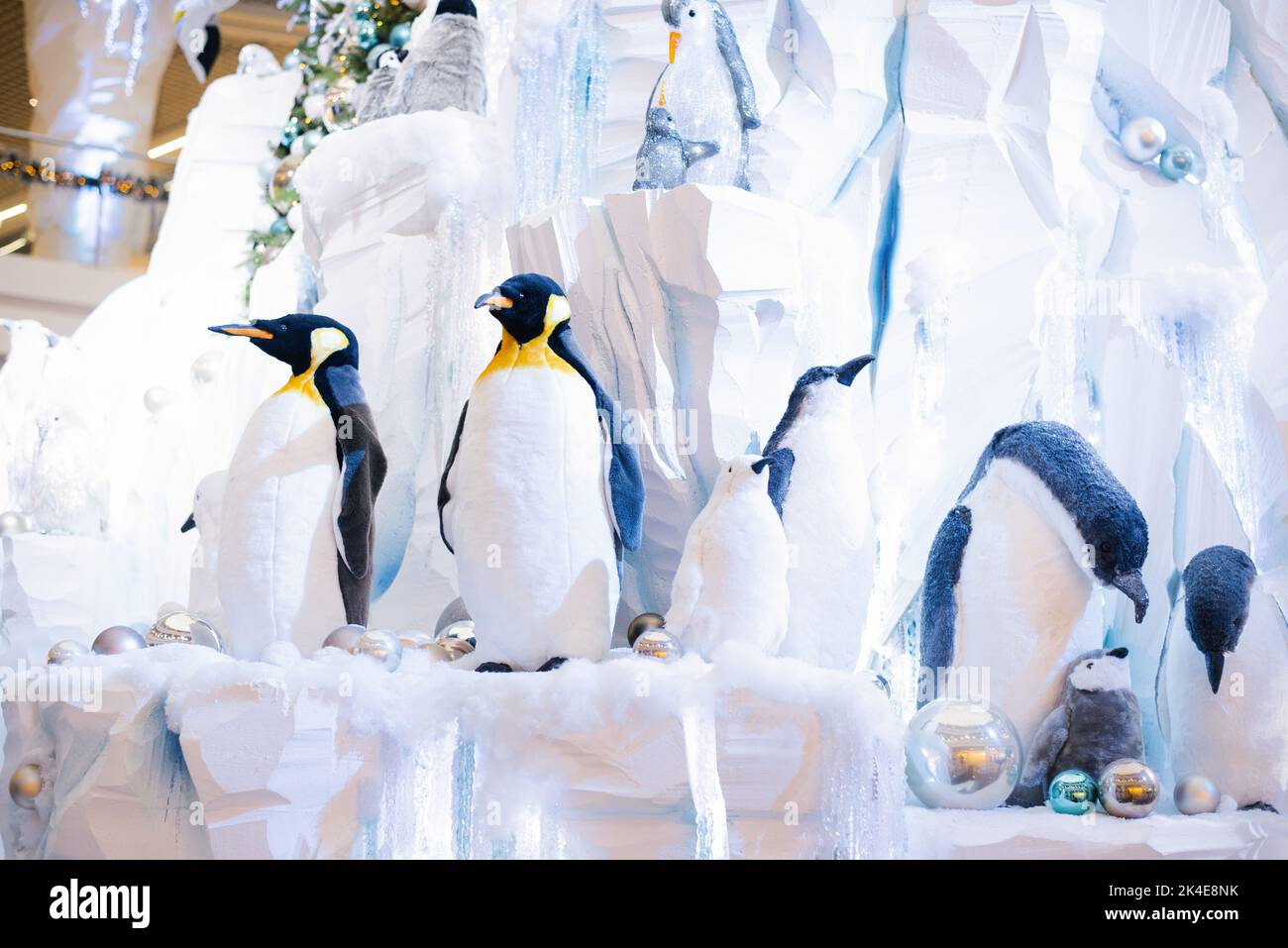 Christmas decor. Ornamental penguins on an artificial iceberg made of