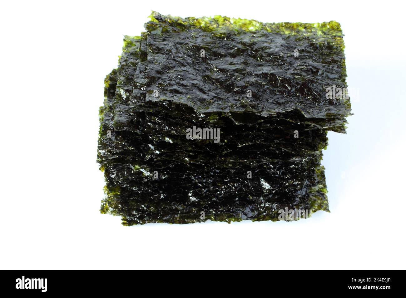 Seasoned seaweed snack. Algae sheets stacked in a pile on white