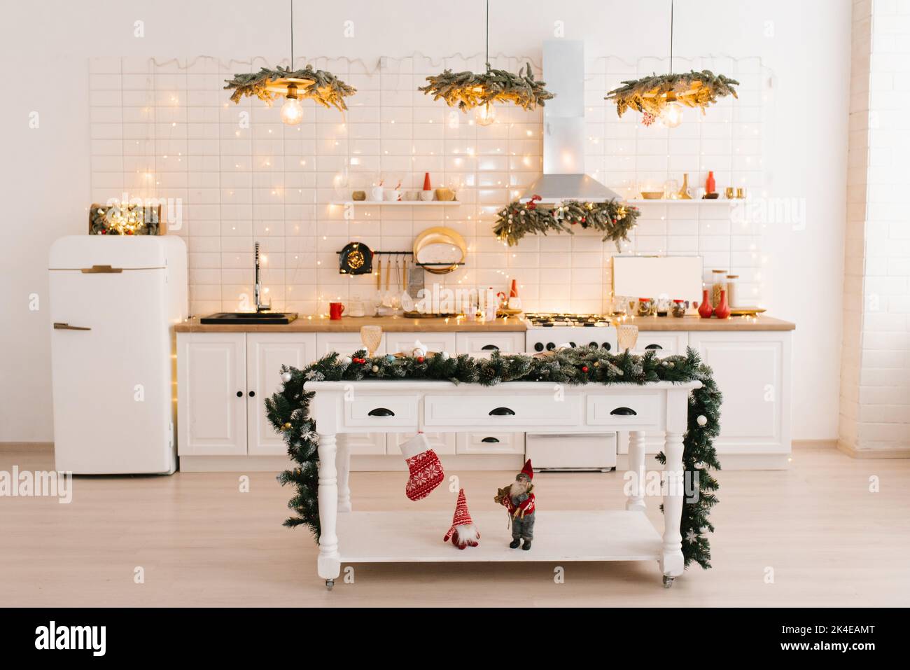 Christmas decor. Bright white kitchen interior with bright garlands and ...