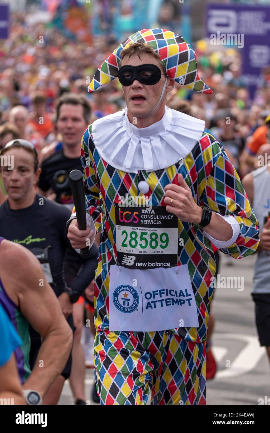 Tower Hill, London, UK. 2nd Oct, 2022. Around 50,000 people are taking part in the 2022 TCS London Marathon, including the world’s top elite runners. The mass of club & fun runners are following with many raising large sums for charity & often running in fancy dress. 28589 Martin Porter. Fastest marathon dressed as a harlequin (male) Stock Photo