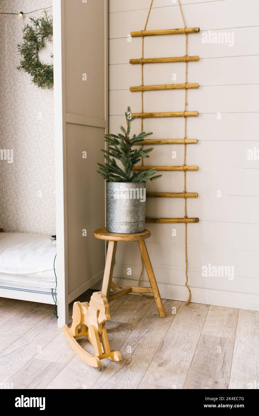 Christmas tree in an iron pot near the closet in the children's room Stock Photo