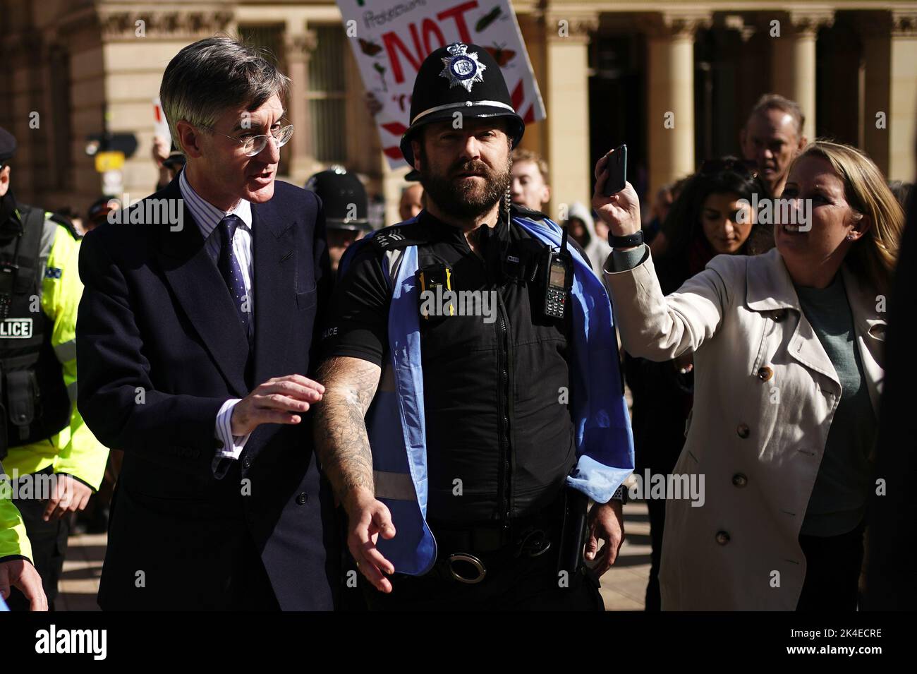 Business Secretary Jacob Rees-Mogg (left) is escorted by a police officer as he arrives at the Conservative Party annual conference at the International Convention Centre in Birmingham. Picture date: Sunday October 2, 2022. Stock Photo