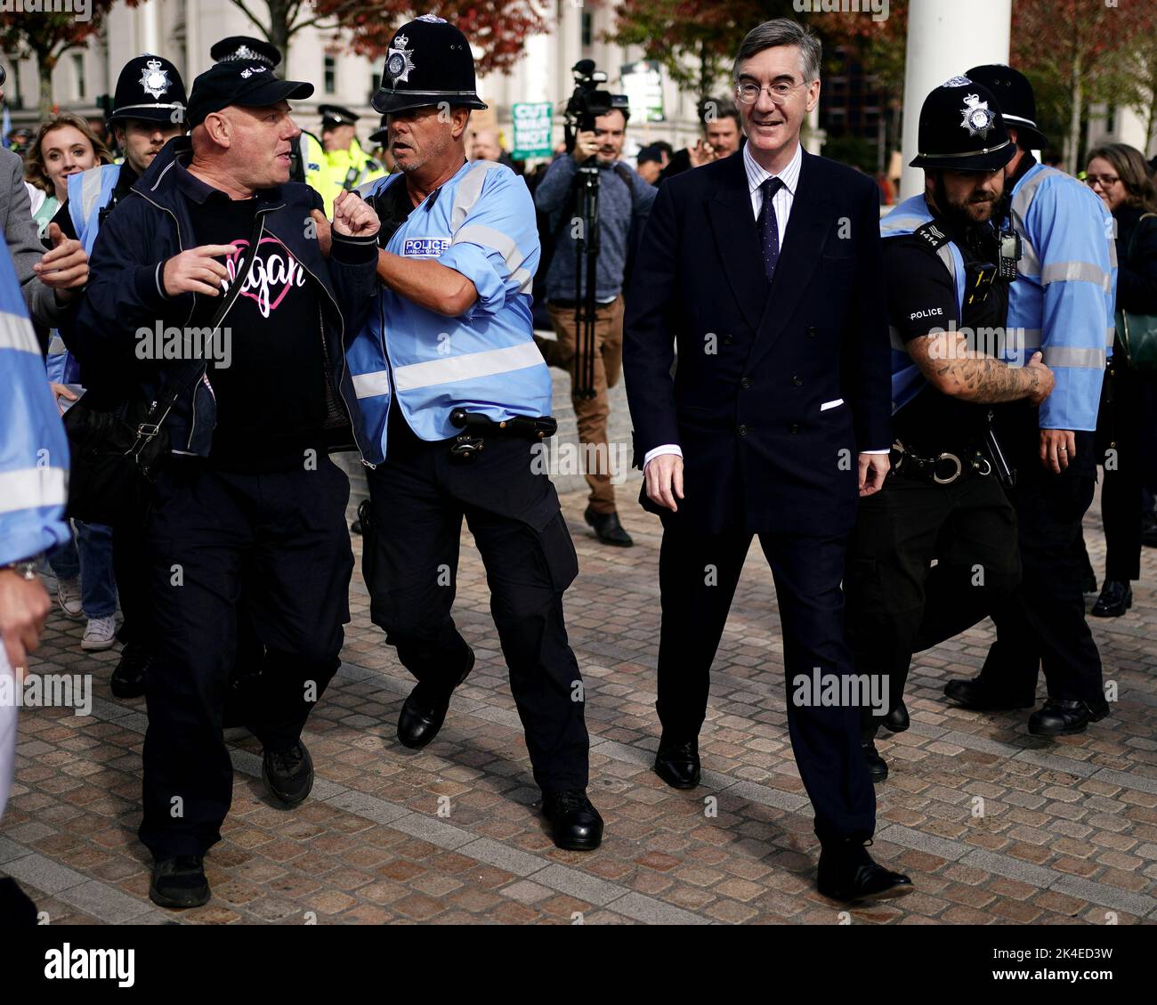 Police officers hold back members of the public as Business Secretary Jacob Rees-Mogg (right) arrives at the Conservative Party annual conference at the International Convention Centre in Birmingham. Picture date: Sunday October 2, 2022. Stock Photo