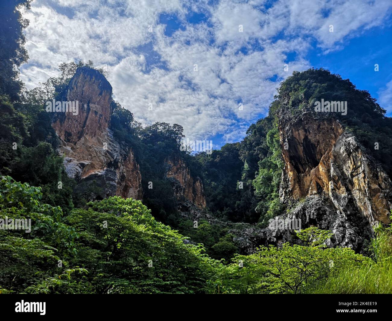 A scenic view of Gunung Rapat mountains covered with greenery in Ipoh