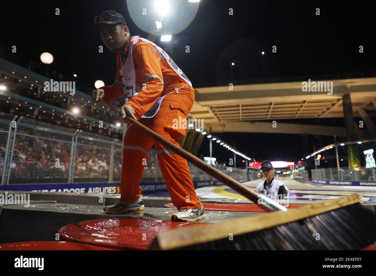 Formula One F1 - Singapore Grand Prix - Marina Bay Street Circuit, Singapore - October 2, 2022 Marshals clear water from the track before the race REUTERS/Edgar Su Stock Photo