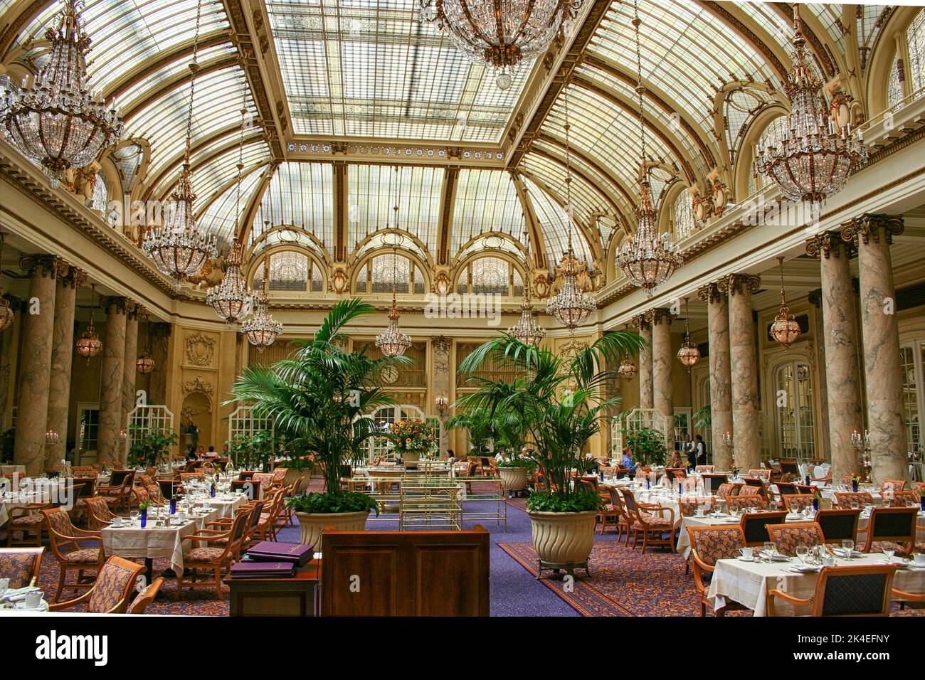 Garden court with stained glass ceiling inside the luxury Palace Hotel