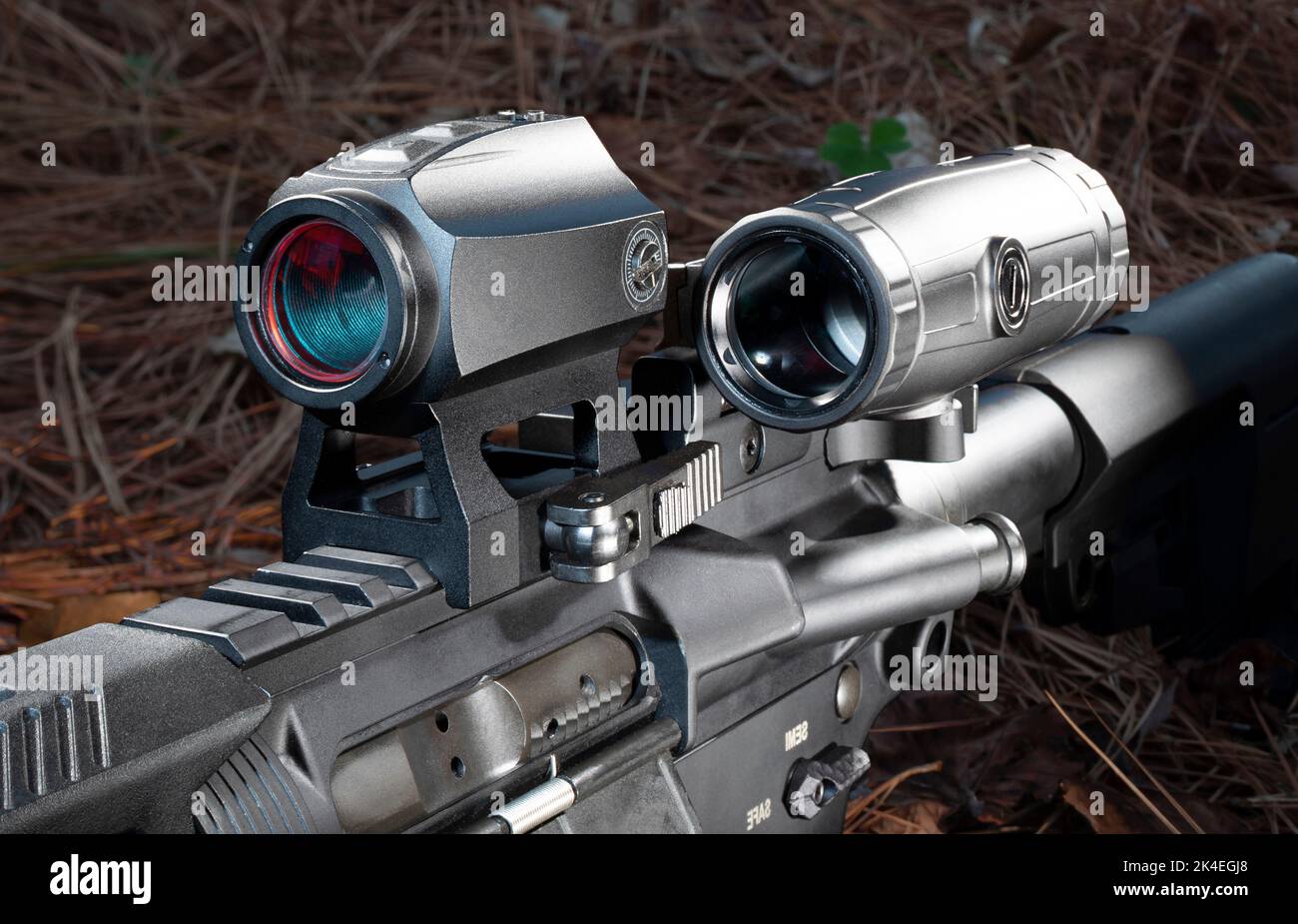 Magnifier to the side of a red dot scope on a modern sporting rifle