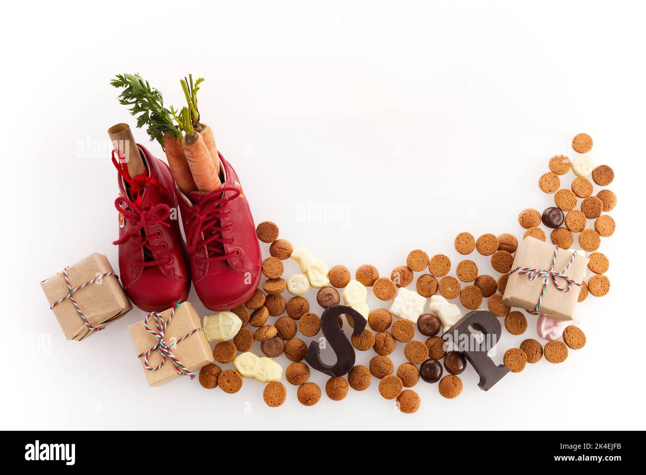 Saint Nicholas - Sinterklaas day with shoe, carrot and traditional sweets on white background Stock Photo