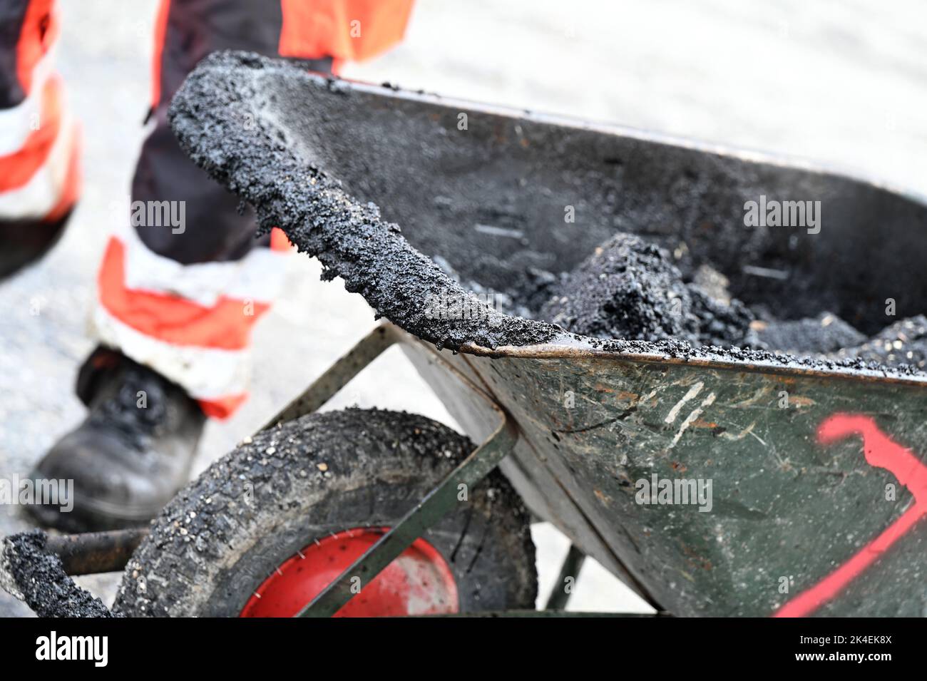 A sliding chest with asphalt and shovel Stock Photo