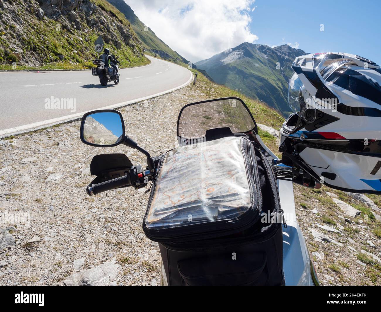 Tank bag with map on an adventure motorcycle at a mountain pass in the Swiss alps. Stock Photo