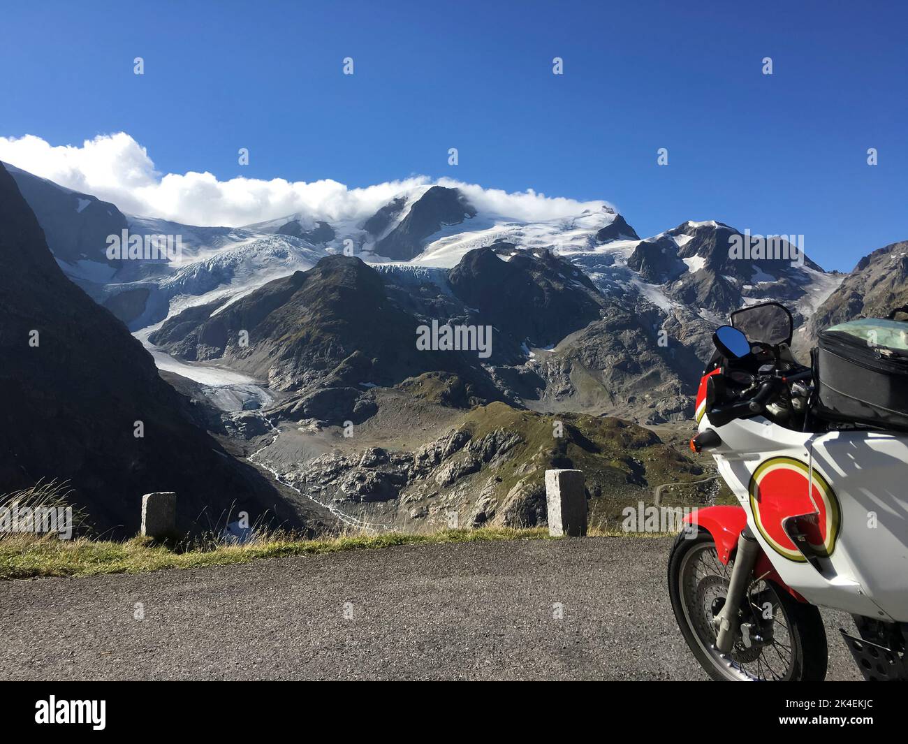 An adventure motorcycle is parked at Susten Pass in the Swiss alps. Stock Photo