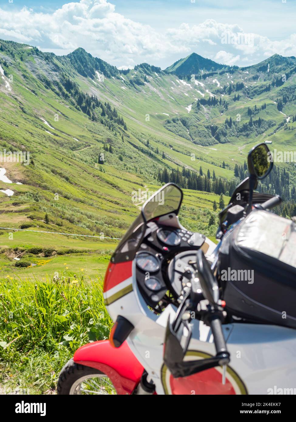 Cockipit of an adventure motorcycle, parked for a break at a pass road in the Swiss alps. Stock Photo