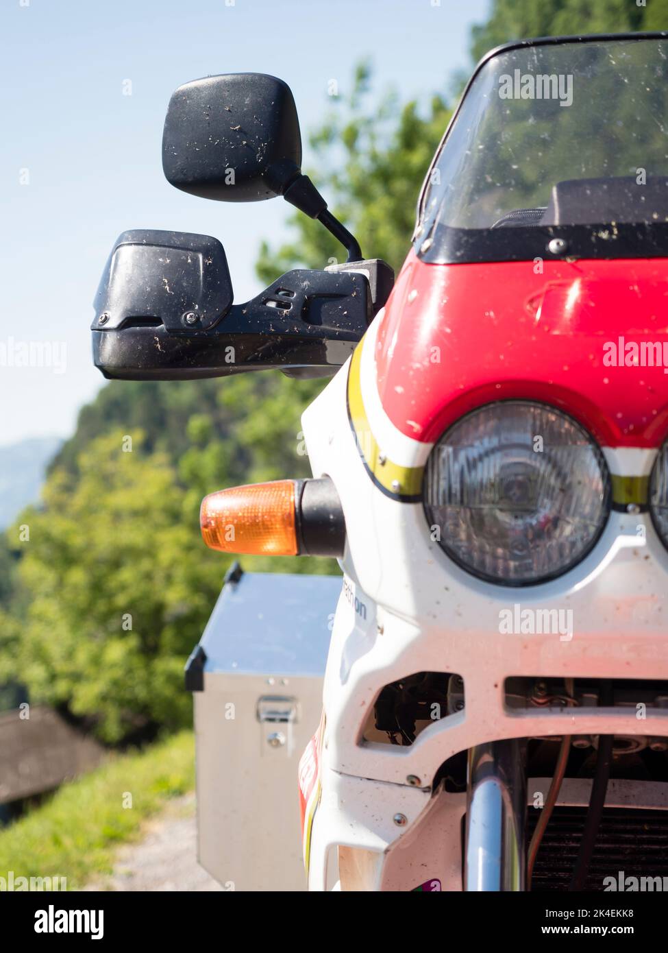 Front view of an adventure motorcycle at a mountain pass in the Swiss alps. Stock Photo