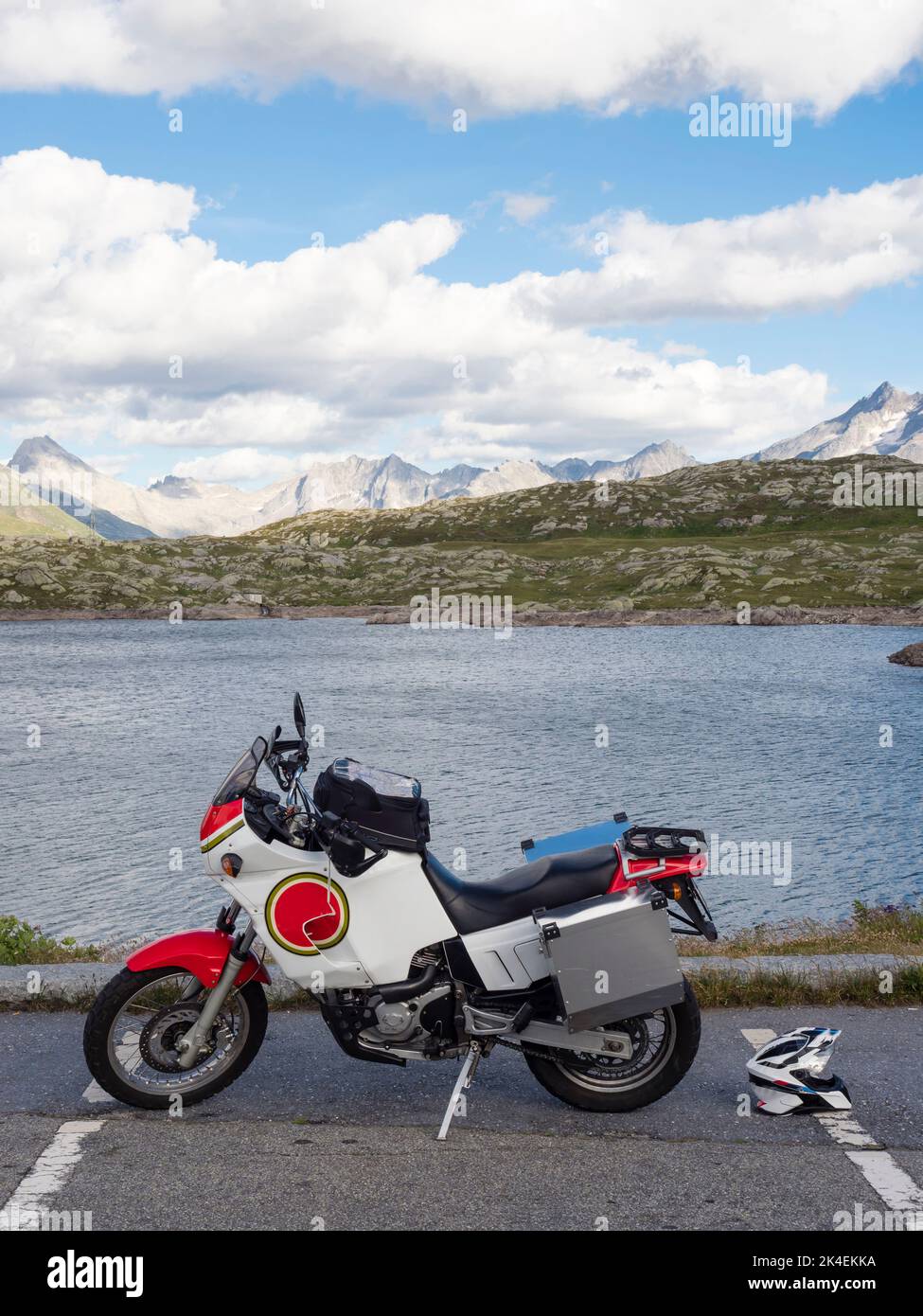 An adventure motorcycle parked at Grimsel pass, a mountain pass in the Swiss alps. Stock Photo