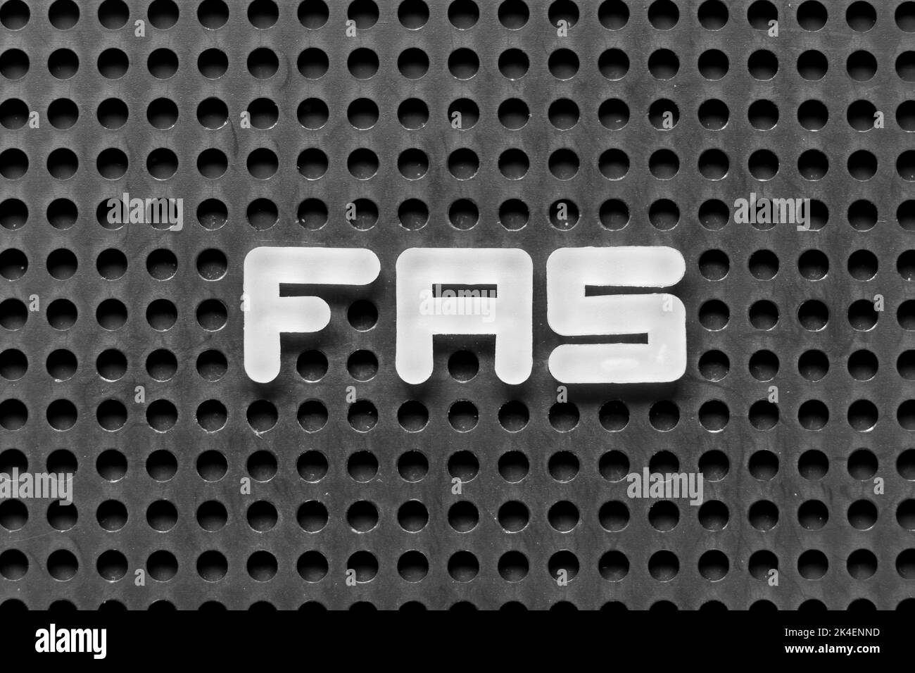White alphabet letter in word FAS (Abbreviation of Fetal alcohol syndrome, Free alongside or Financial accounting standards) on black pegboard backgro Stock Photo