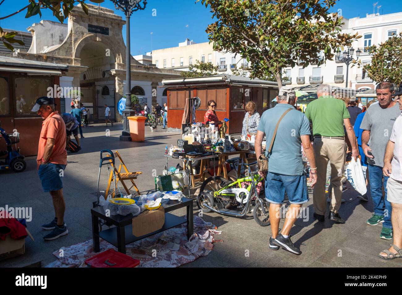 Flea market in the streets located in the old town part of Cadiz, Spain. Vendors selling secondhand antiques & collectables to curious tourists. Stock Photo