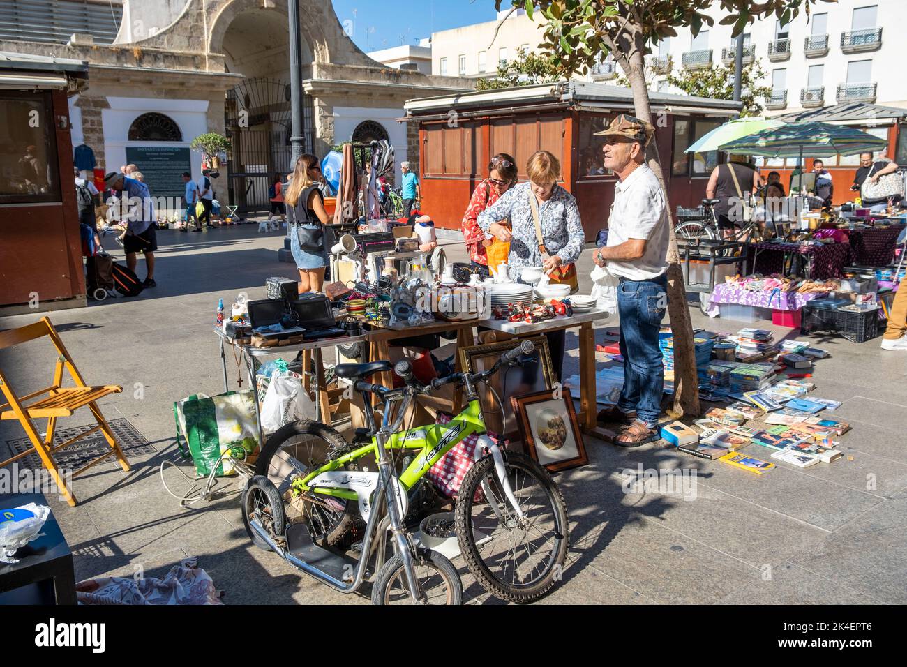 Flea market in the streets located in the old town part of Cadiz, Spain. Vendors selling secondhand antiques & collectables to curious tourists. Stock Photo