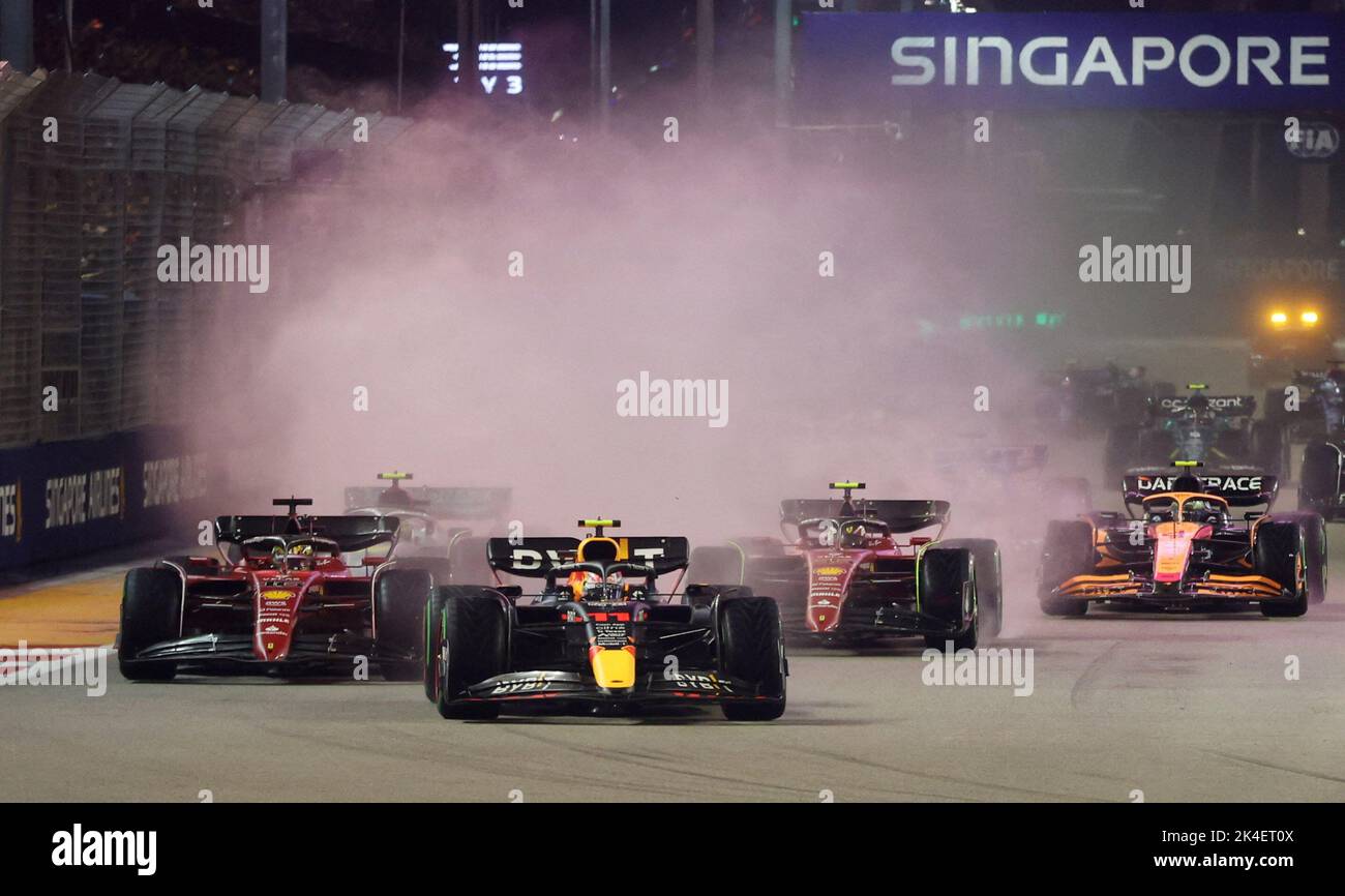 Formula One F1 - Singapore Grand Prix - Marina Bay Street Circuit, Singapore - October 2, 2022 Red Bull's Sergio Perez in action ahead of Ferrari's Charles Leclerc and Ferrari's Carlos Sainz Jr. REUTERS/Edgar Su Stock Photo